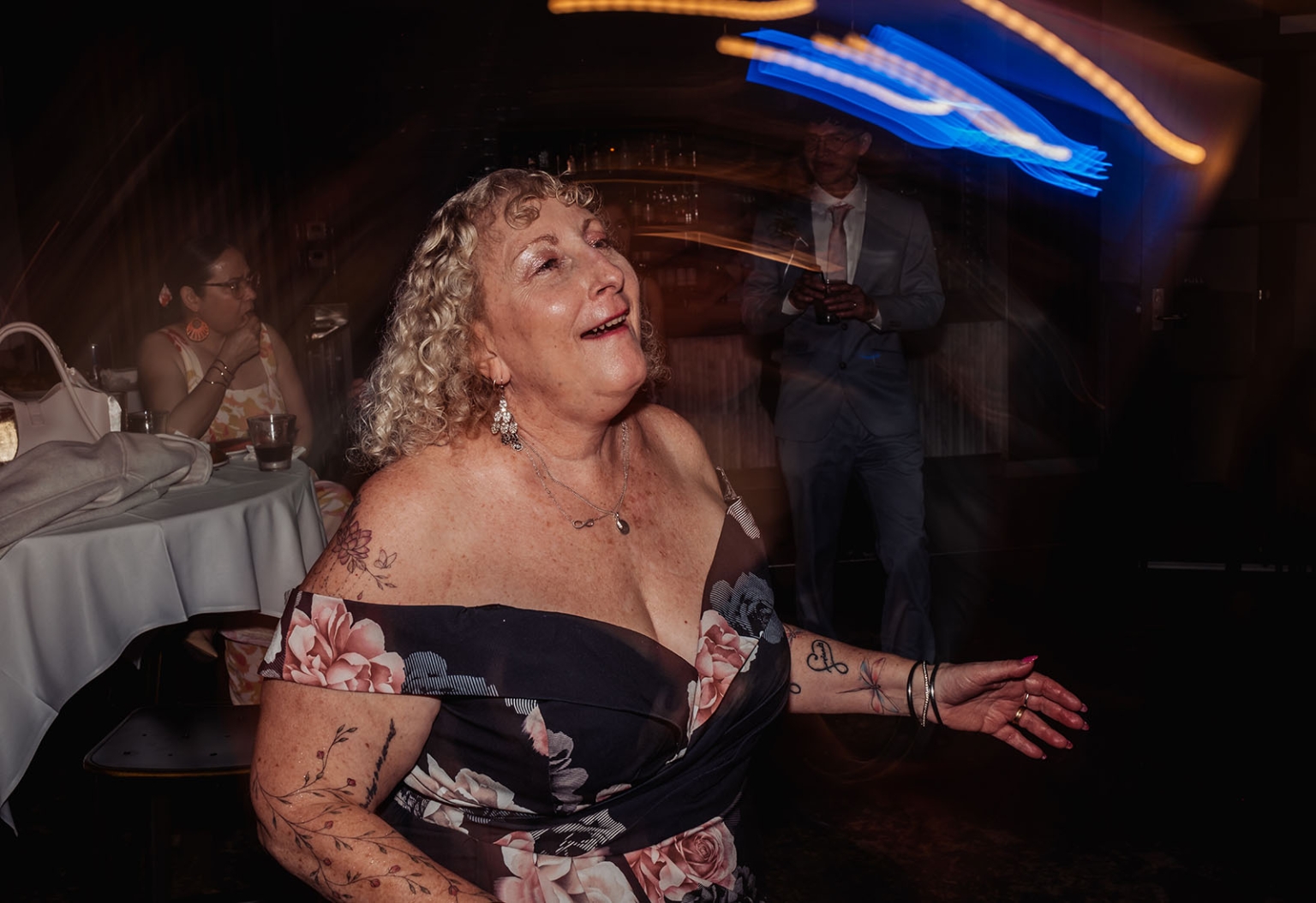 hotel royal wedding - brad & manuel 44 Wedding guest dancing beneath blue and amber light trails at Hotel Royal