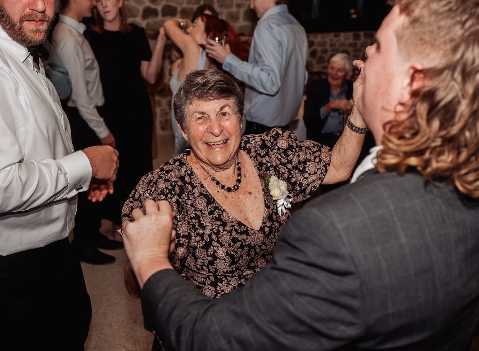 st joseph's chapel wedding – diana & michael 52 Smiling elderly wedding guest dancing with raised arms among guests at the reception