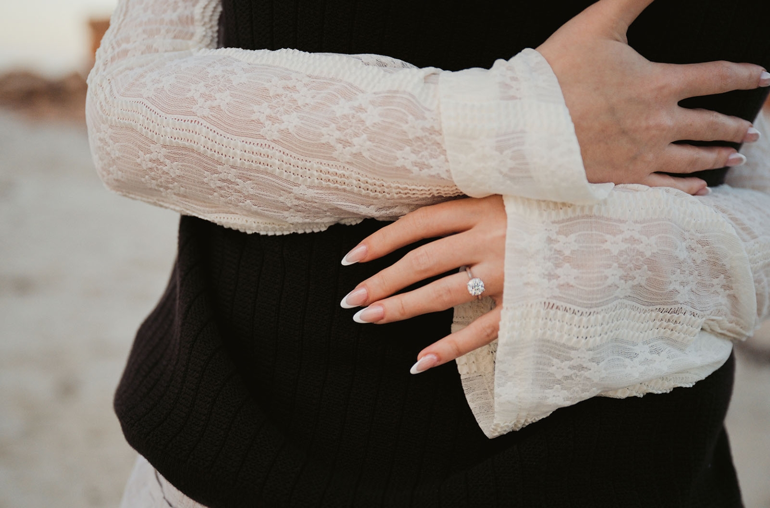 moonta's simms cove proposal – zoe & nathan 26 Close-up of Zoe’s hand wearing an engagement ring as she embraces Nathan at Simms Cove, Moonta