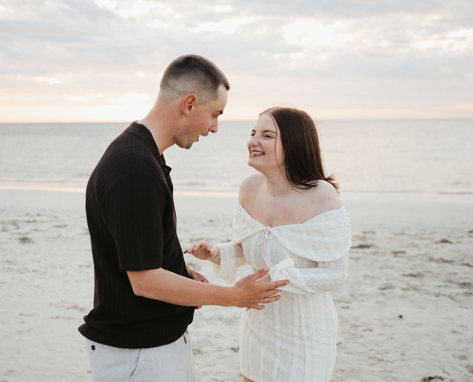 moonta's simms cove proposal – zoe & nathan 27 Zoe and Nathan smiling at each other on the beach at Simms Cove, Moonta