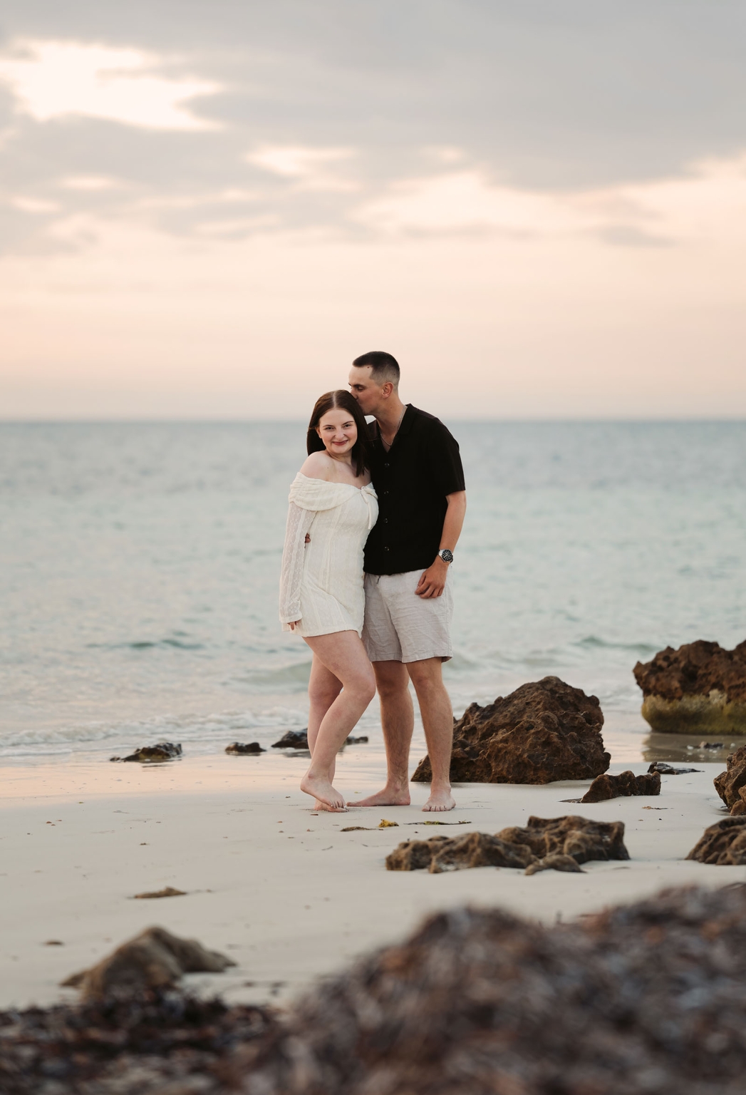 moonta's simms cove proposal – zoe & nathan 29 Zoe and Nathan standing barefoot together on the rocky beach at Simms Cove, Moonta