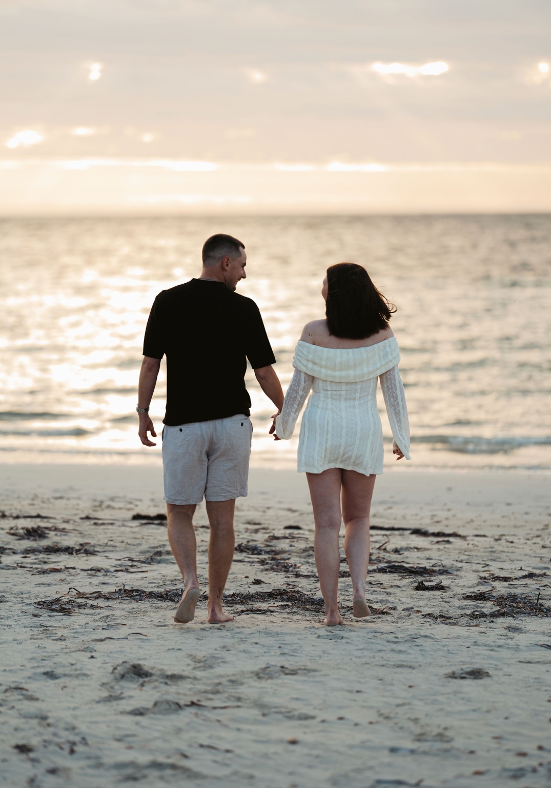 moonta's simms cove proposal – zoe & nathan 13 Zoe and Nathan walking hand in hand along Simms Cove beach at sunset